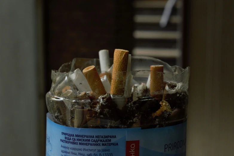 cigarettes in an ashtray on a table top