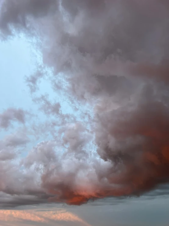 a large plume of smoke from an airplane flying in the sky