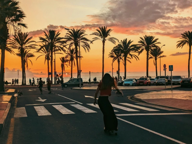 the lady on the skateboard is crossing the street