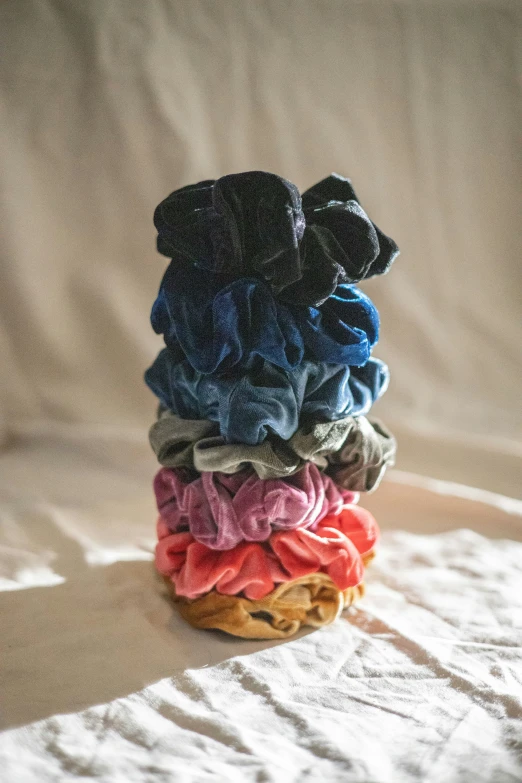 four different colored fabric piled on each other