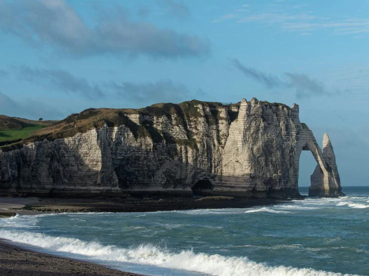 a tall cliff sticking out from the ocean