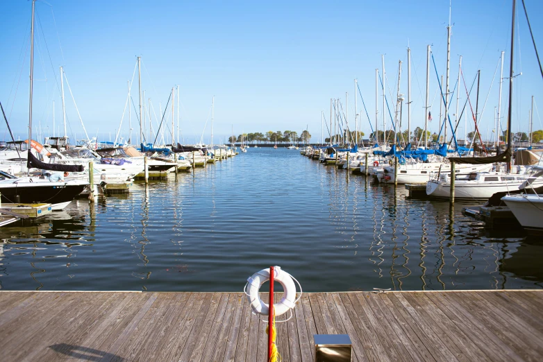 boats are docked at a pier in the water