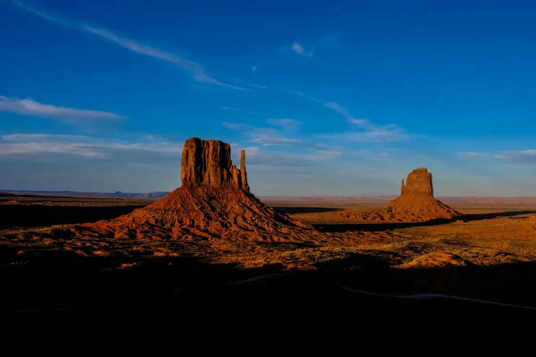 two tall rocks sticking out from the desert