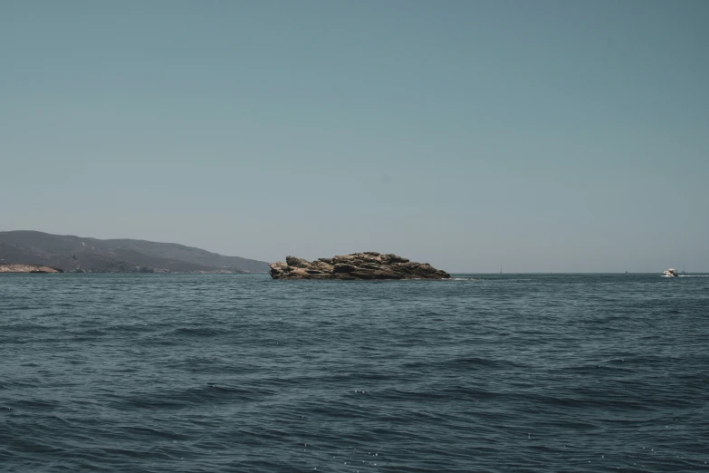 the big rock sits alone in the middle of the water