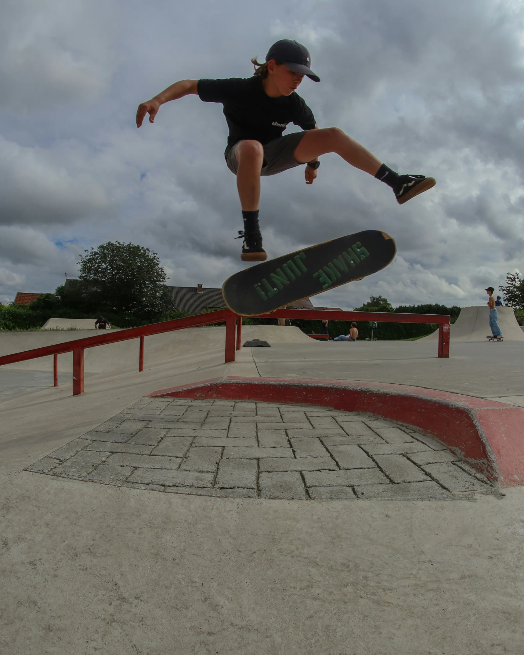 a boy is airborne after performing his skateboard trick