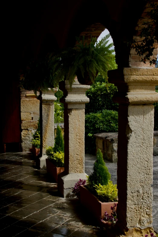 a couple of planters that are near a stone wall