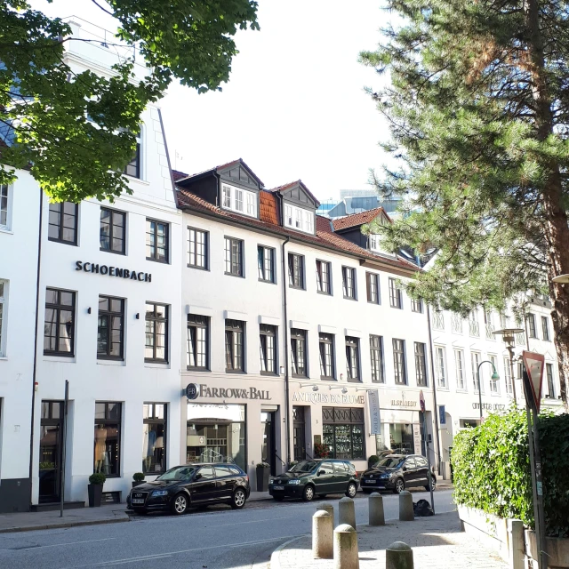 a row of white buildings sit on the corner