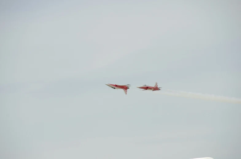 two jets that are flying in the air