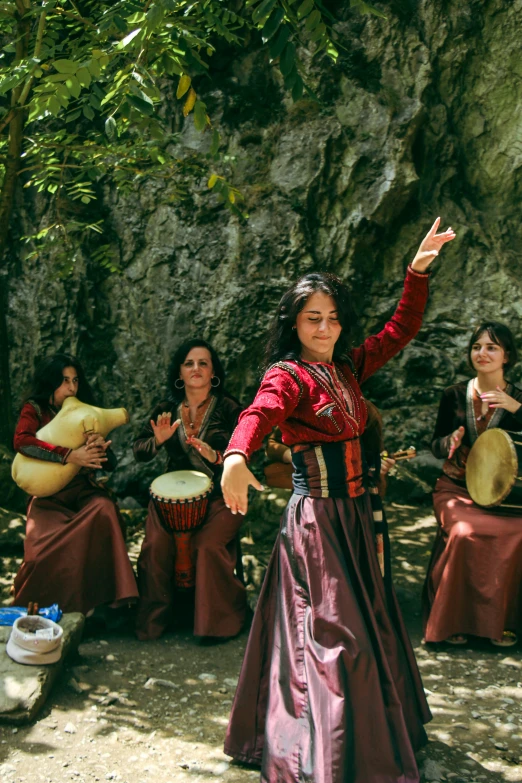 a group of woman sitting around each other while playing musical instruments