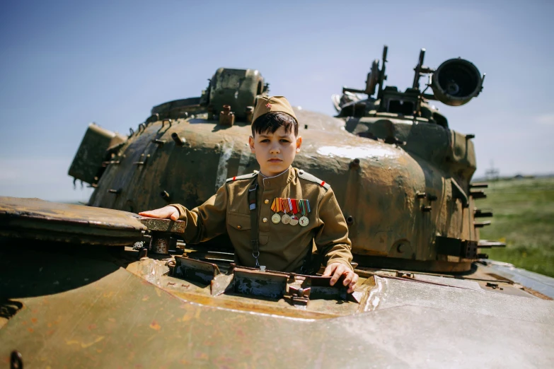 a  sitting on top of a tank