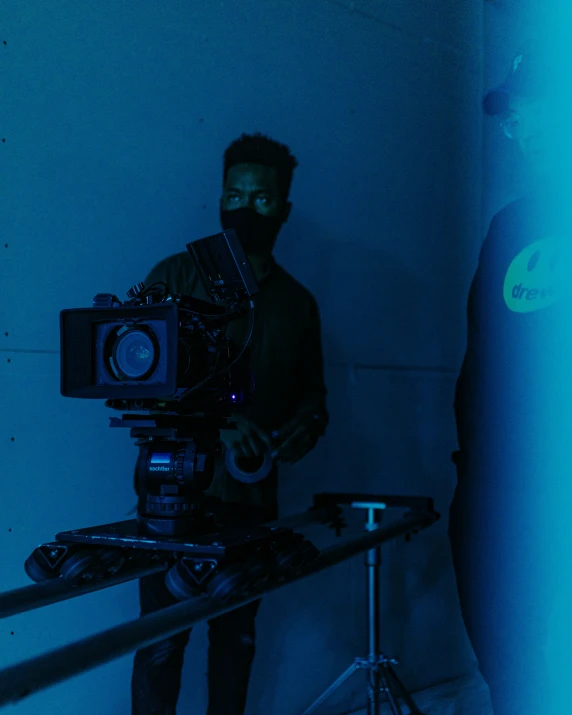 a cameraman holding a video camera at night in a dark room