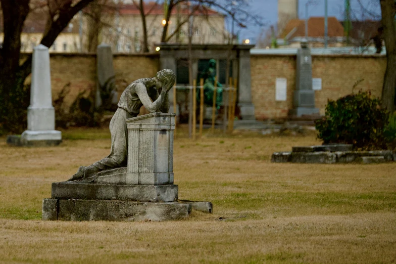 there is a cement sculpture sitting in a field