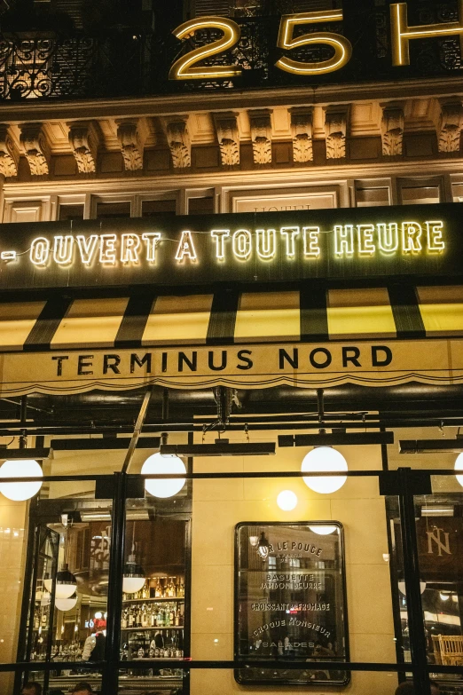 a close up of a building at night with the neon on it