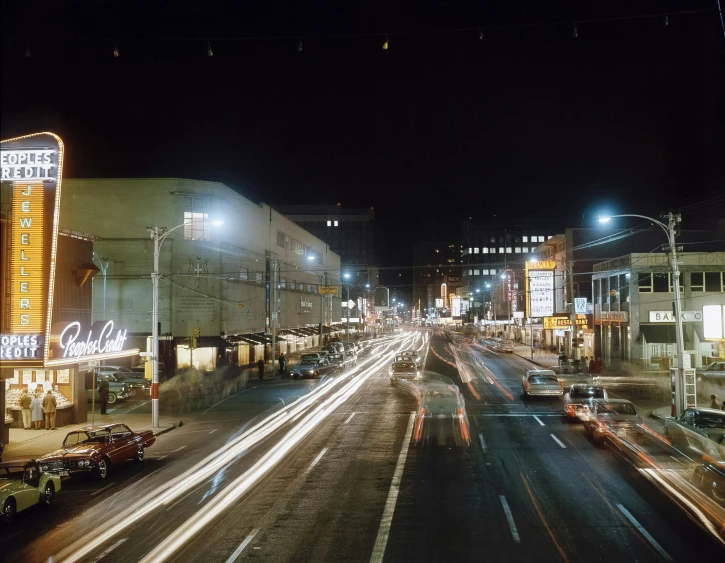 a nighttime s of a street with buildings and neon lights