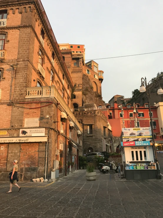 a large building on a street with people walking around