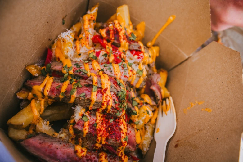 a box that has a knife, fork and some food in it