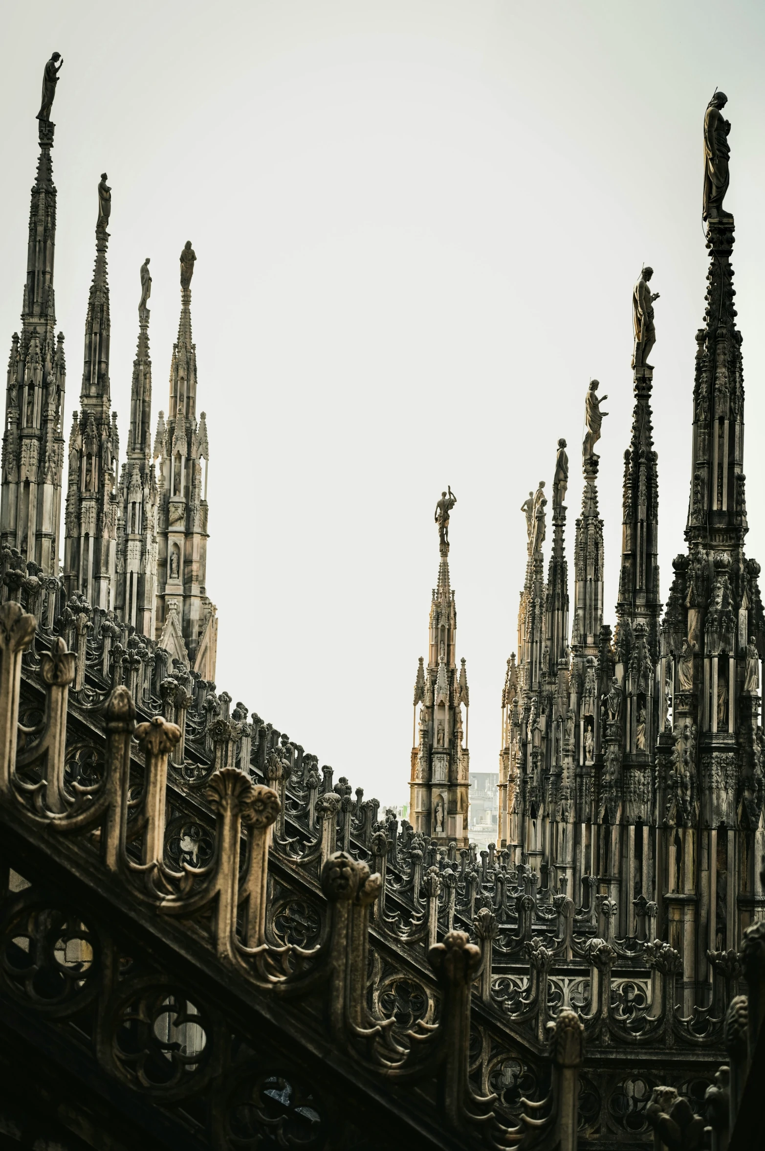 a very tall church with lots of windows next to an ornate roof