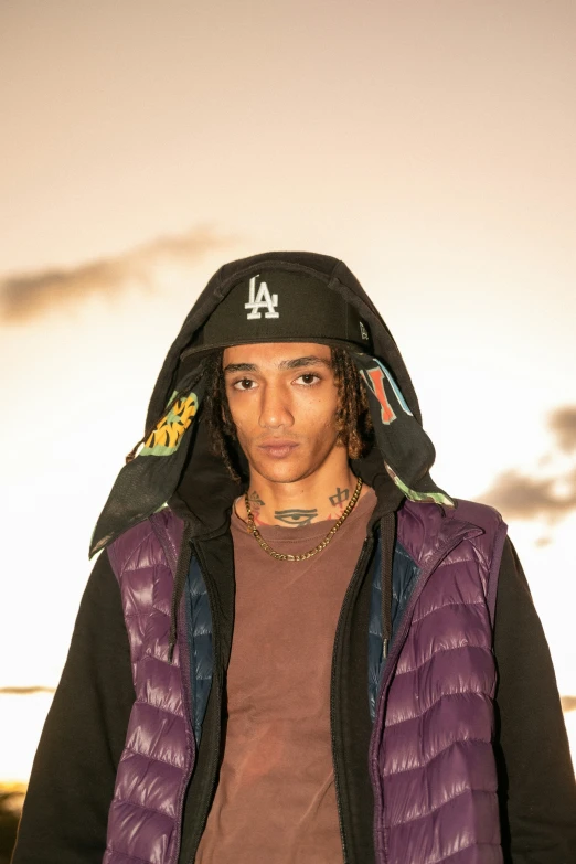 a man in a purple and black hooded jacket