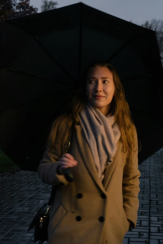 a woman is holding an umbrella and smiling at the camera