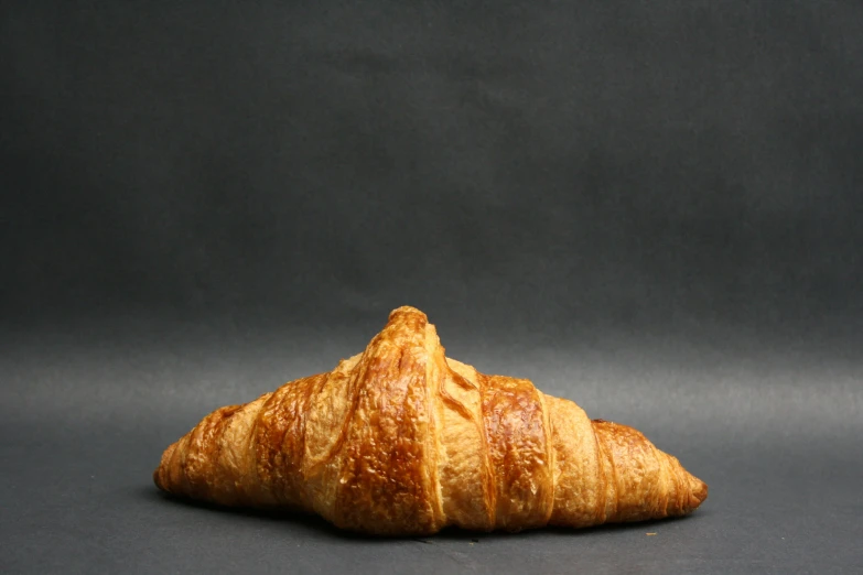 there is a croissant on the table that looks like a hat