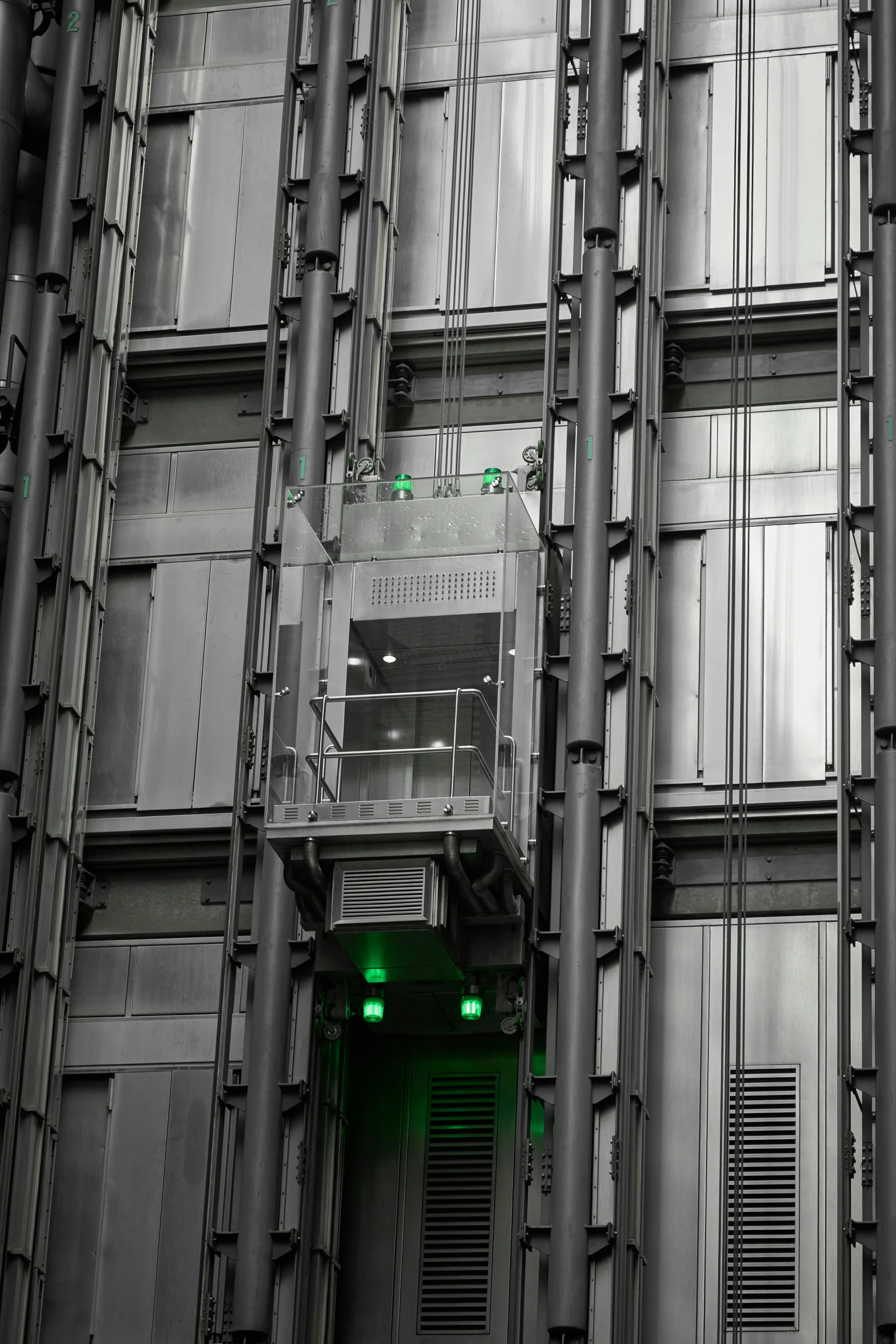 a green door in an industrial building with grey architecture