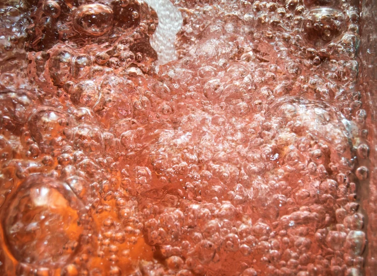 a brown substance is bubbles in the water