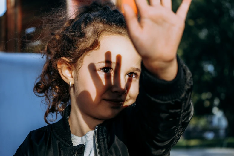 a woman standing with her hand over her face