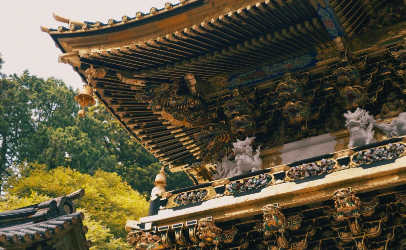 a statue and roof of an asian style house