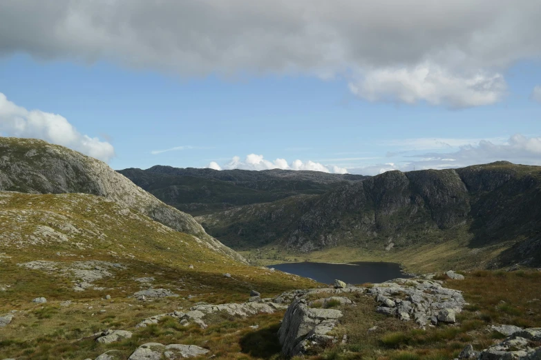 a large mountain lake next to some rocks