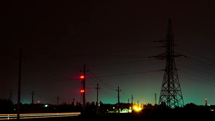 a power pole at night lit up with red and blue lights