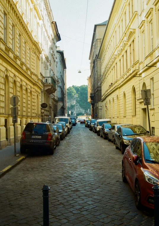 some cars parked along the side of a street