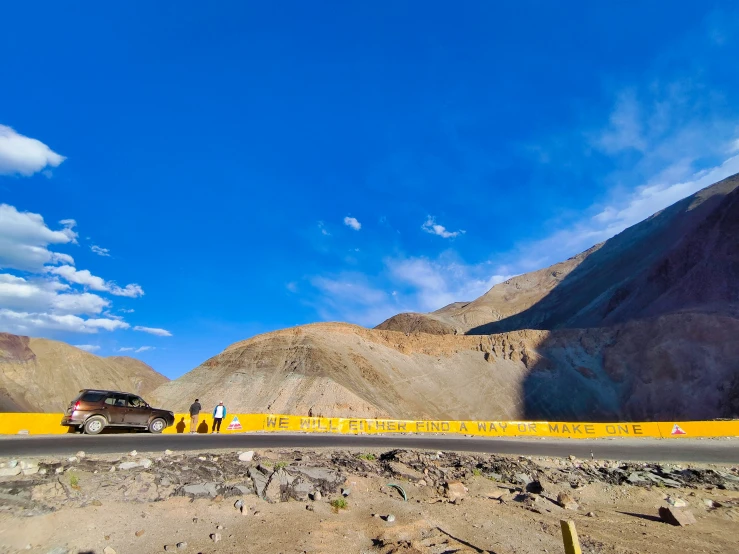 a truck driving down a road in a remote area