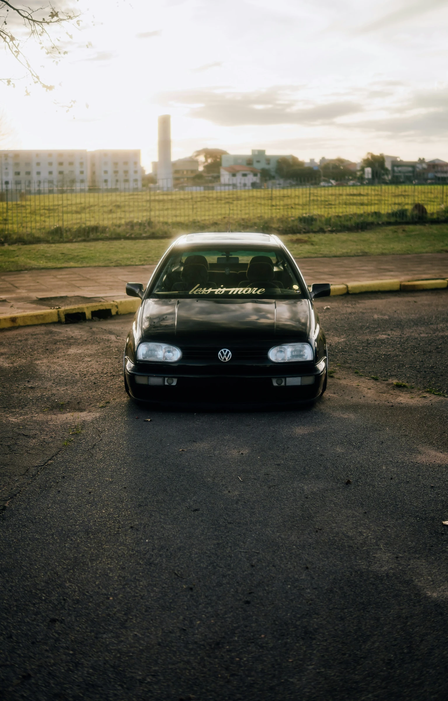 the car is parked near an industrial area