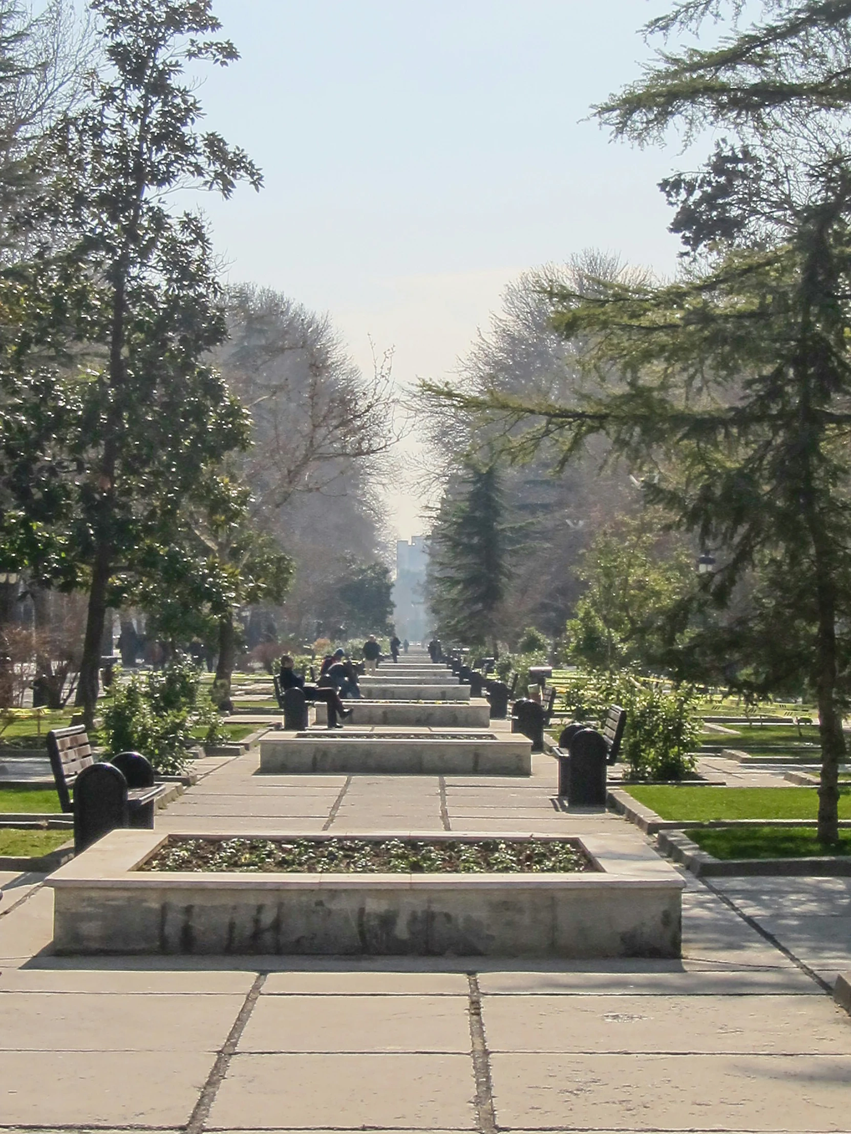 this is a park with many benches and trees