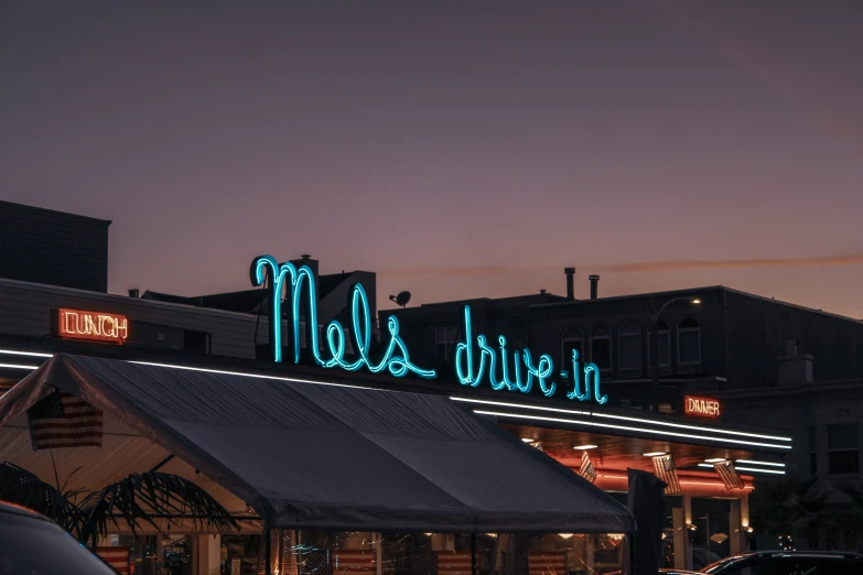 a small restaurant with neon sign for the diner