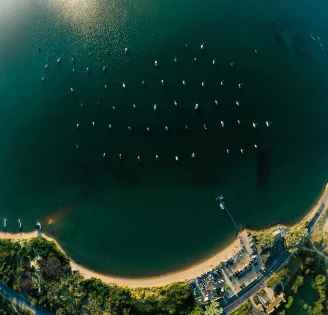 an aerial view of some boats in the water