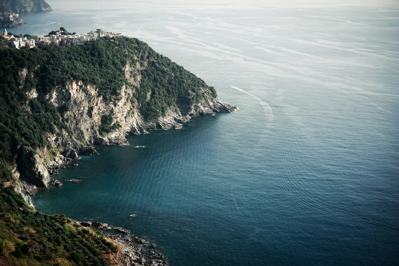 some water and a large hill by the ocean