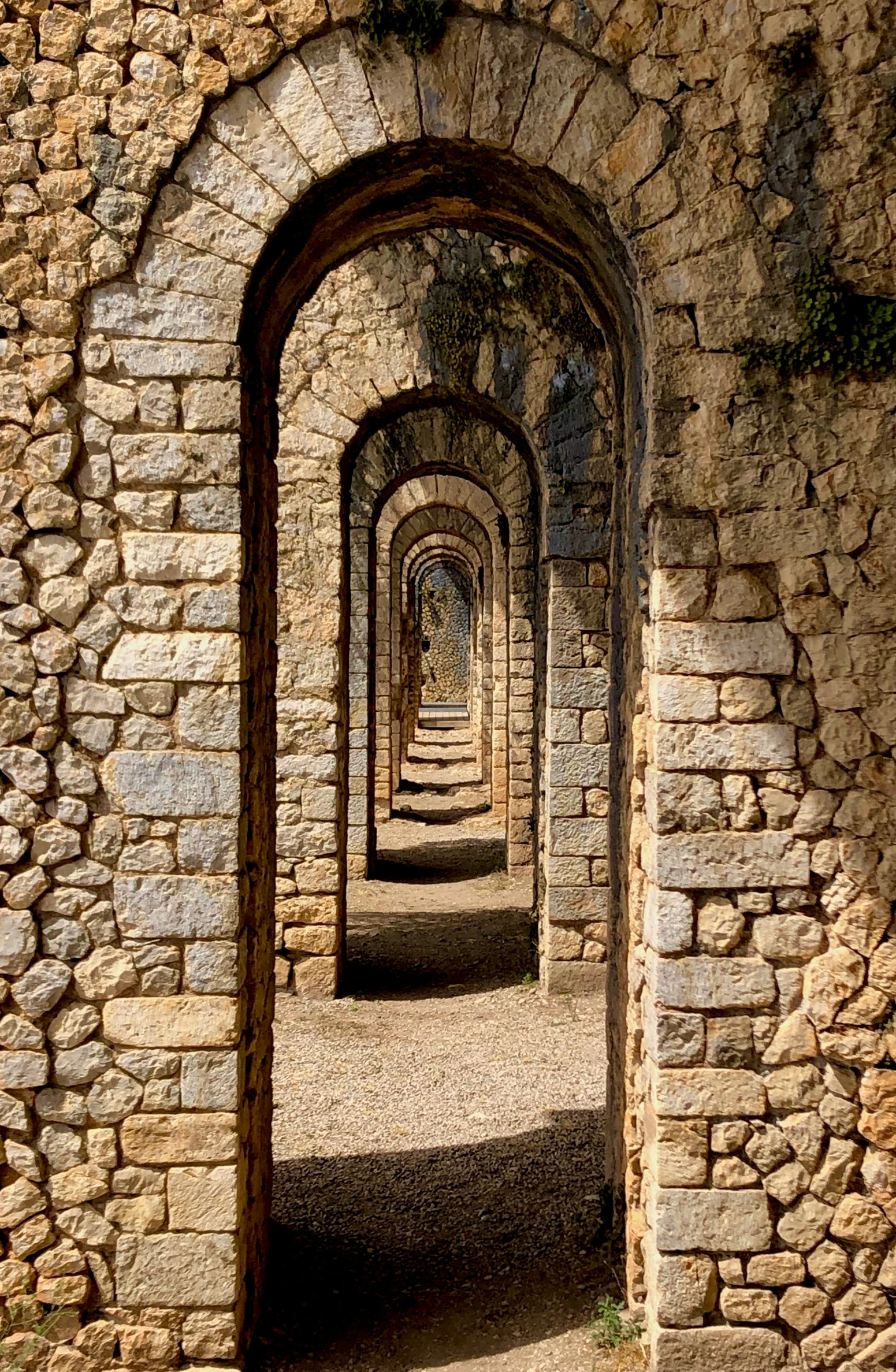 a tunnel leads into another room in an old building