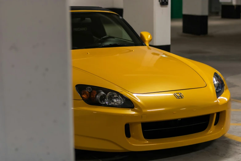 a yellow car parked next to a building