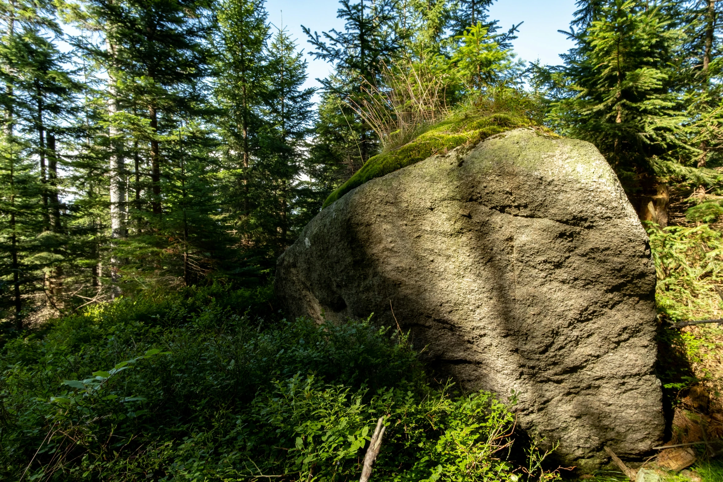 the very large rock is very tall and thick