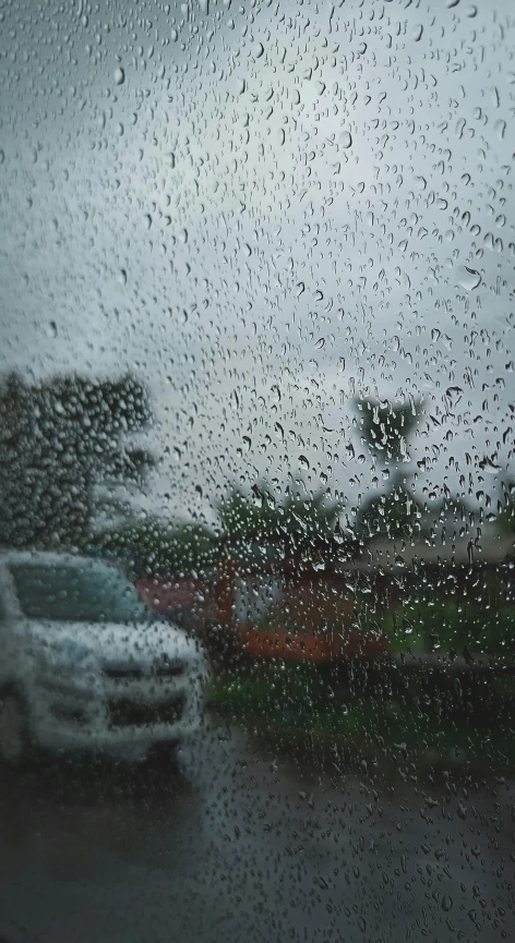 some rain is covering the windshield outside a car