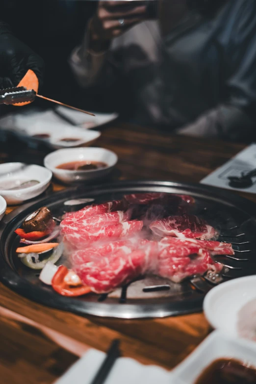 some meats are being fried on an open grill