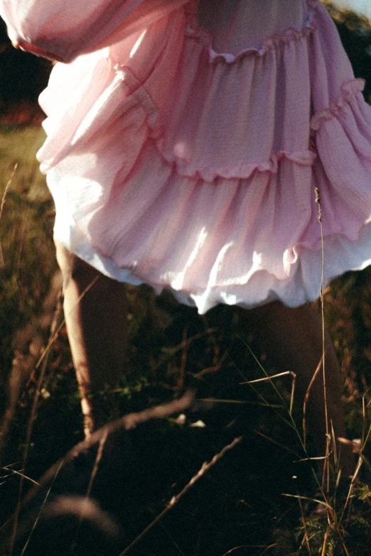 a person in dress standing in tall grass