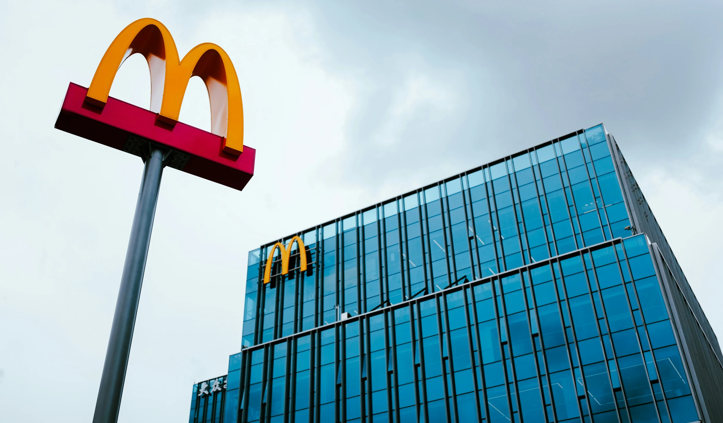 the top of a restaurant sign is visible behind an office building