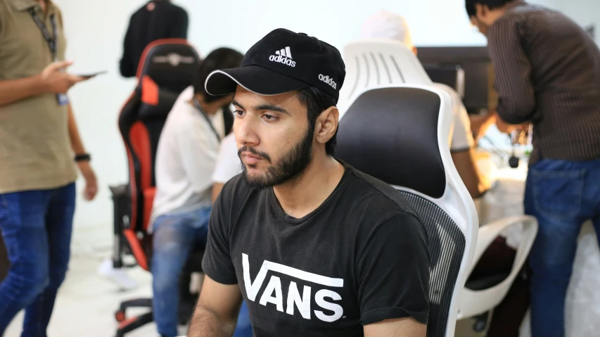 a man sits in a chair next to an office