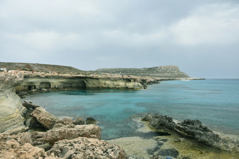 the blue waters of the beach have many rocks