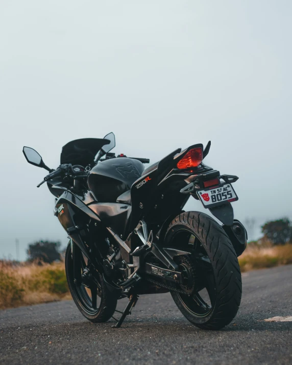 a very sleek motorcycle sitting on the side of the road