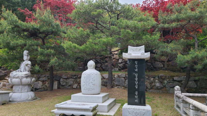 the chinese statues sit along with trees in the background