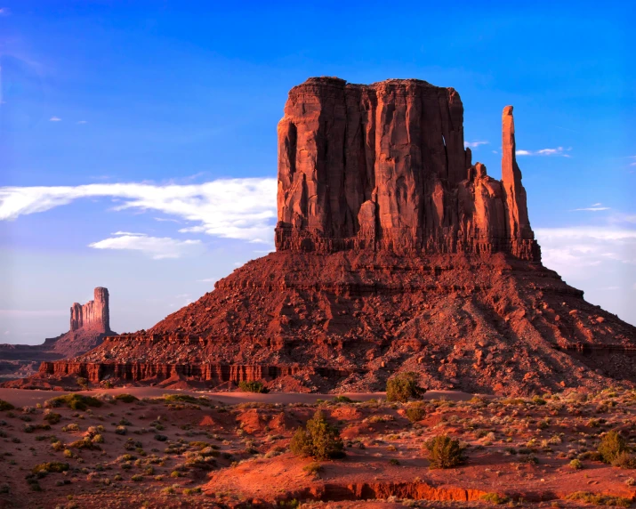 a tall rock formation sitting in the middle of a desert