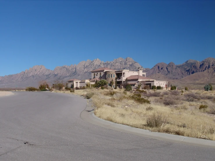 a large house with mountains in the background